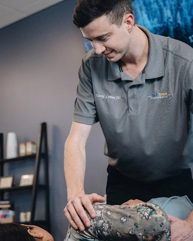 Dr. Corey J. Miller adjusting a patient's knee