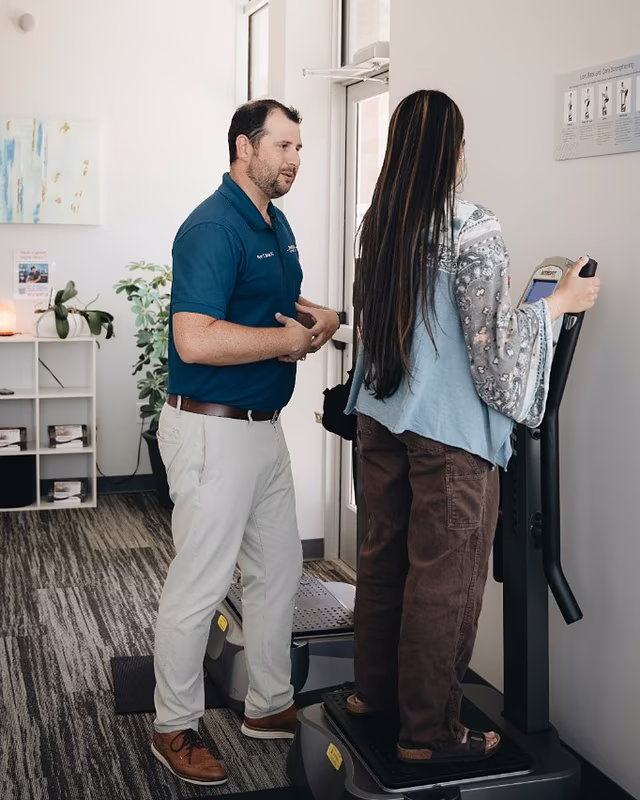 A TexStar chiropractor guiding a patient through a balance exercise