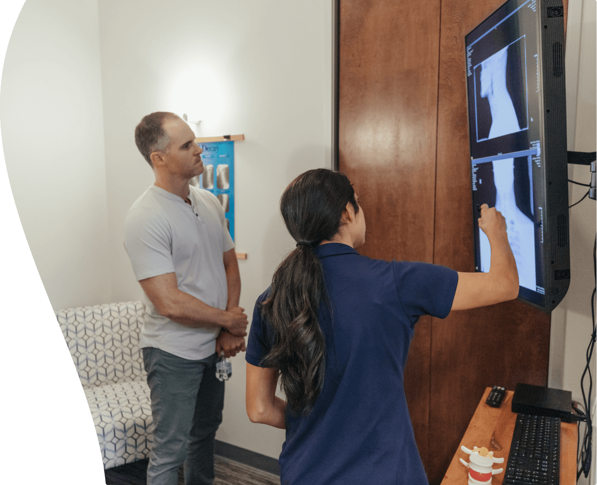 Dr. Claudia Zavala showing an x-ray to a client