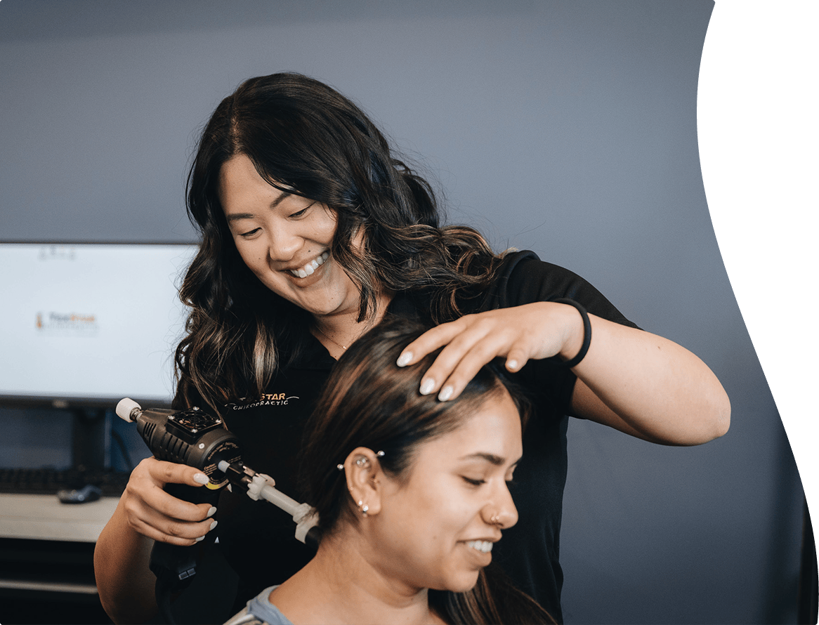 Dr Tran helping a woman with neck pain