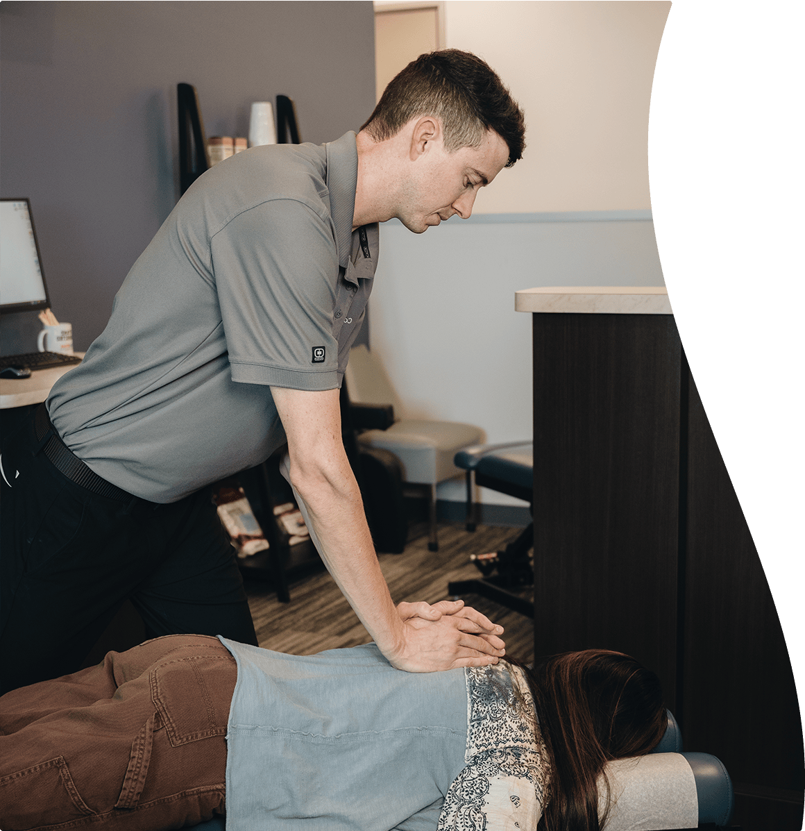 Dr Zavala adjusting a client on the table with nerve pain