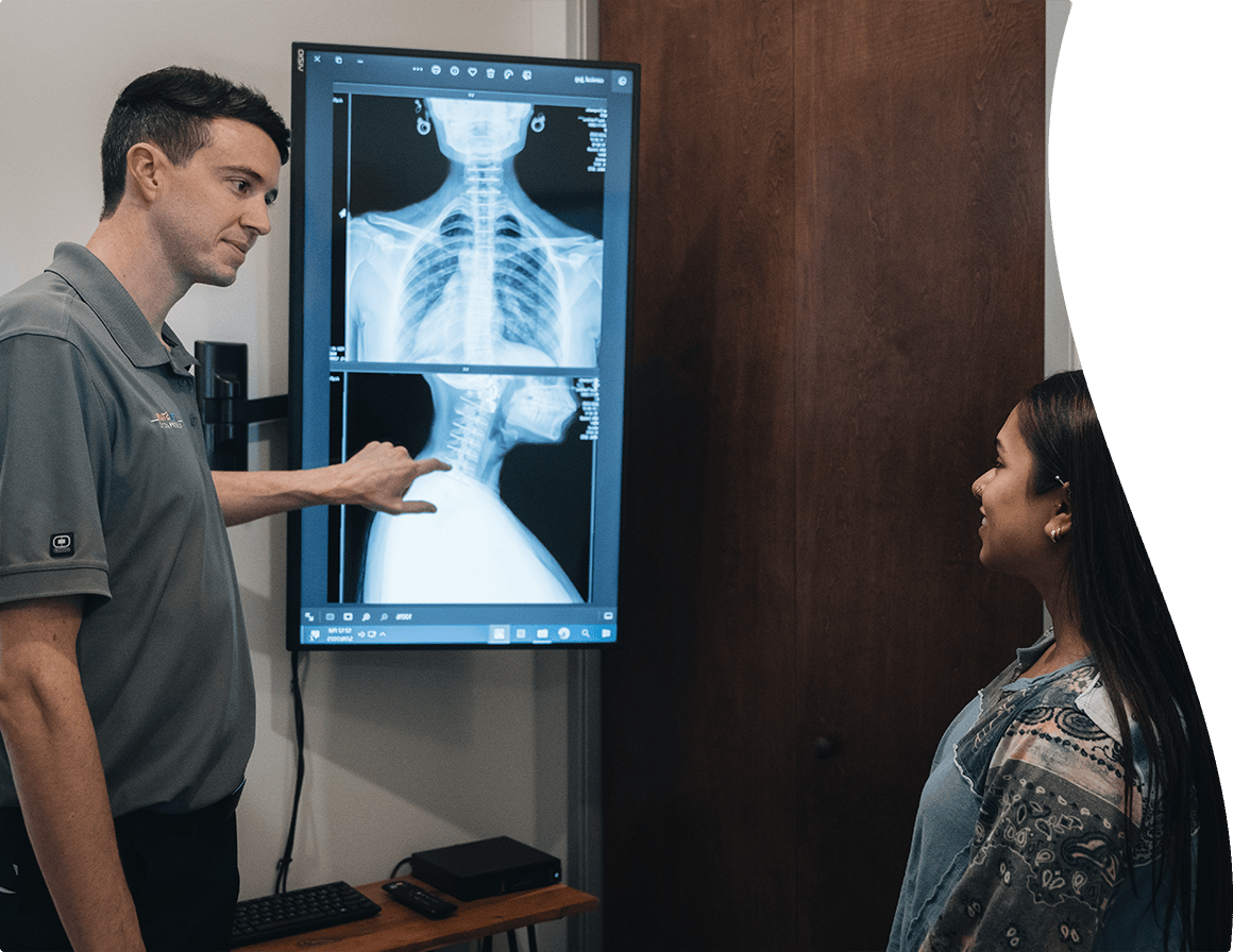 Dr Zavala showing a client an x-ray from whiplash damage